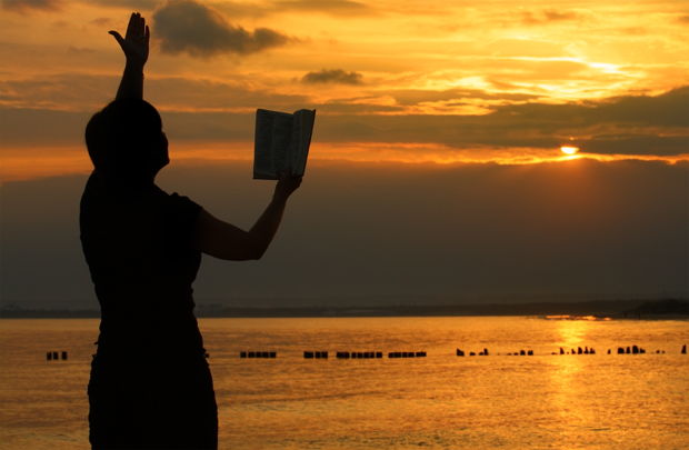 female praying with bible